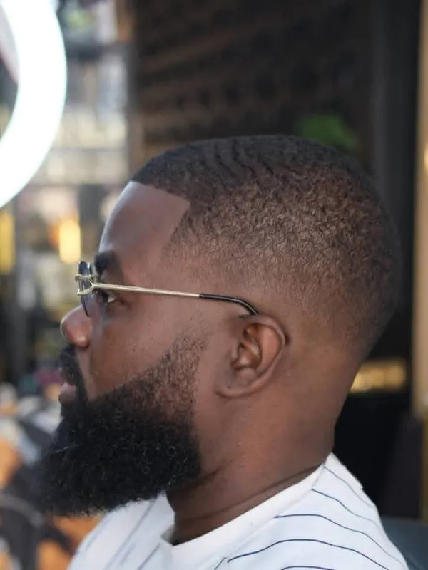 Full beard shaped into a taper fade