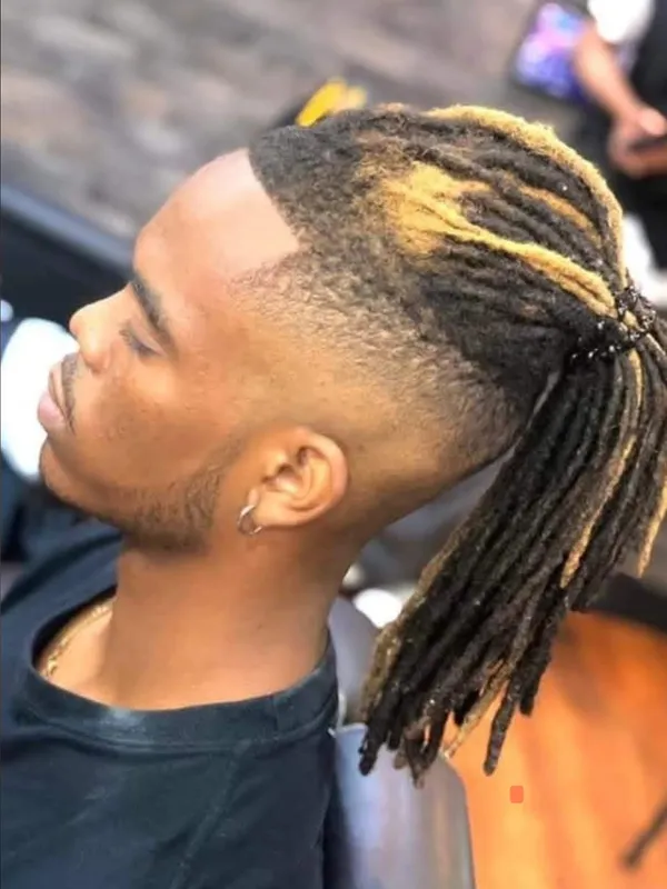 Blonde tipped locs with a burst fade