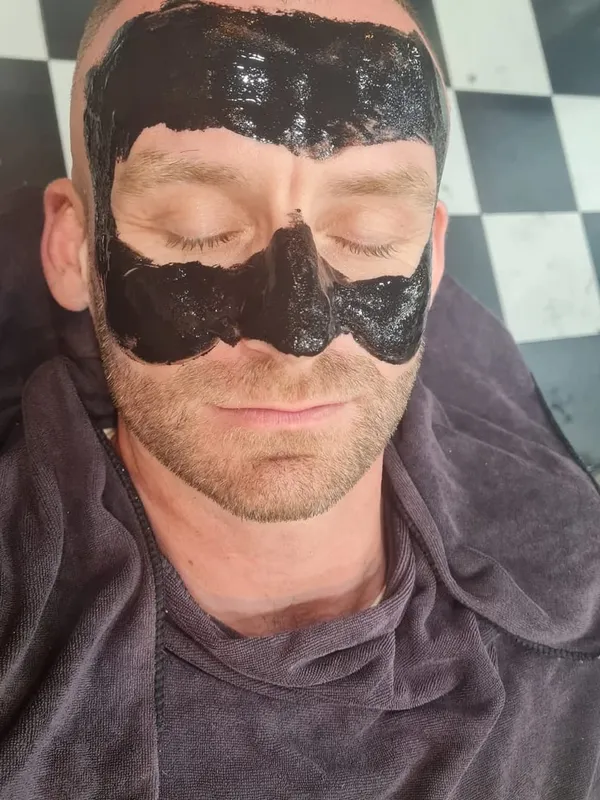 Black mask facial on a client