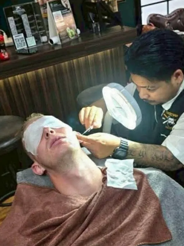 Barber cleaning a client's ears