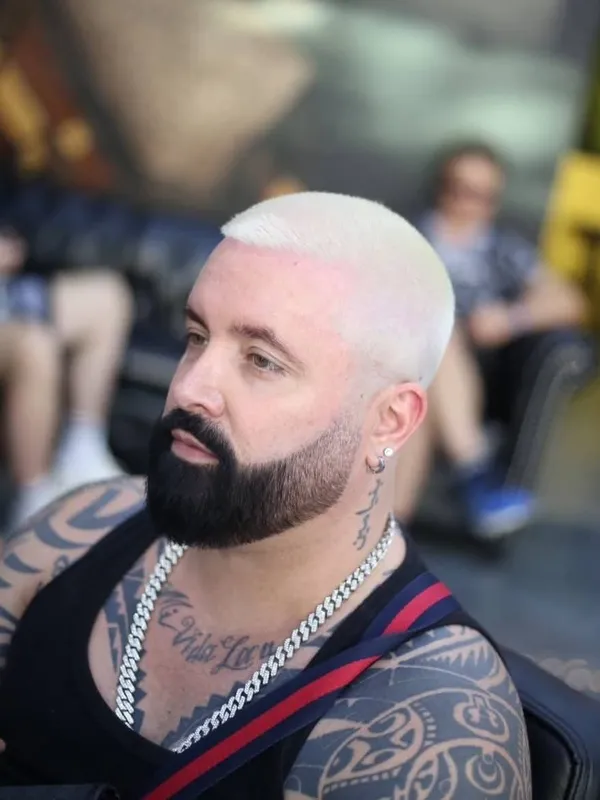 Platinum buzz cut with a black beard