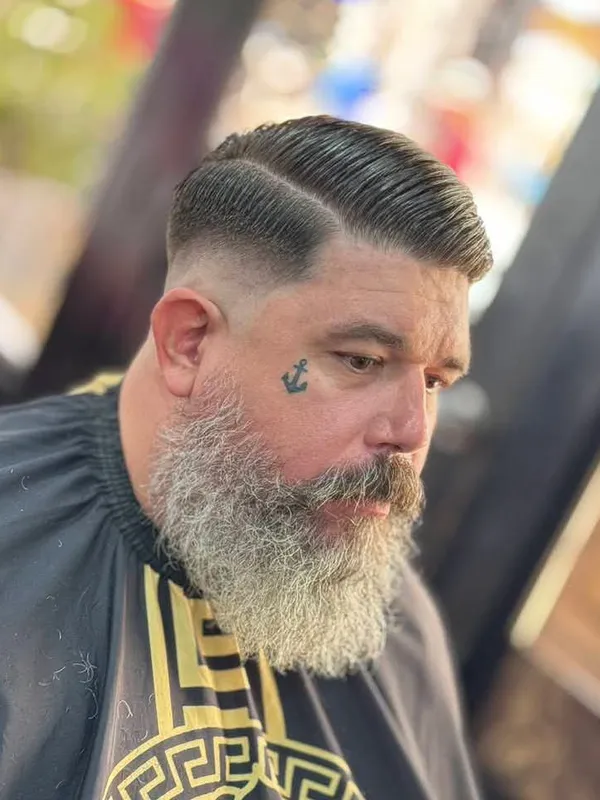 Full grey beard with a side part fade