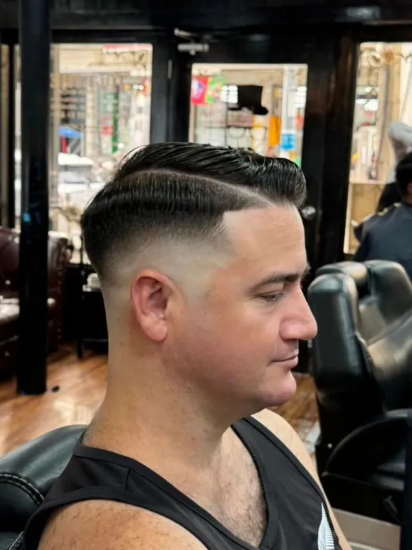 Side part with a hard line and taper