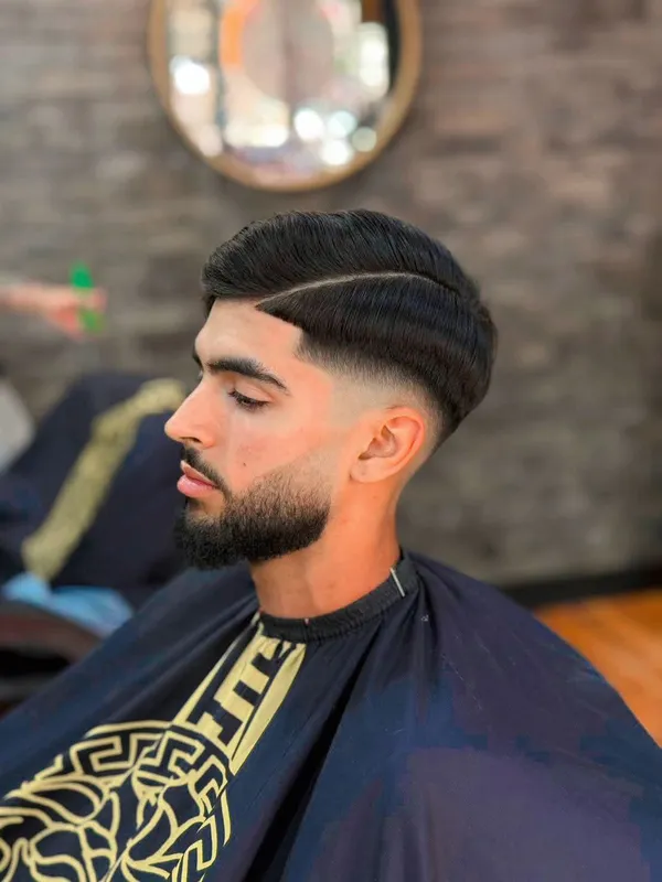 Hard part with a skin fade and shaped beard