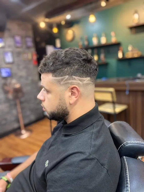Hair design on a high fade with beard