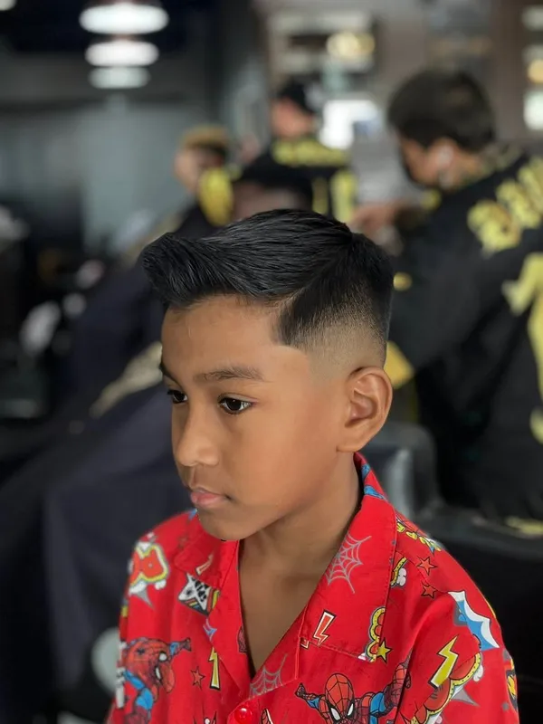 Boy with a short side part and taper