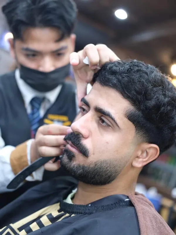 Beard shaped with a comb and scissors