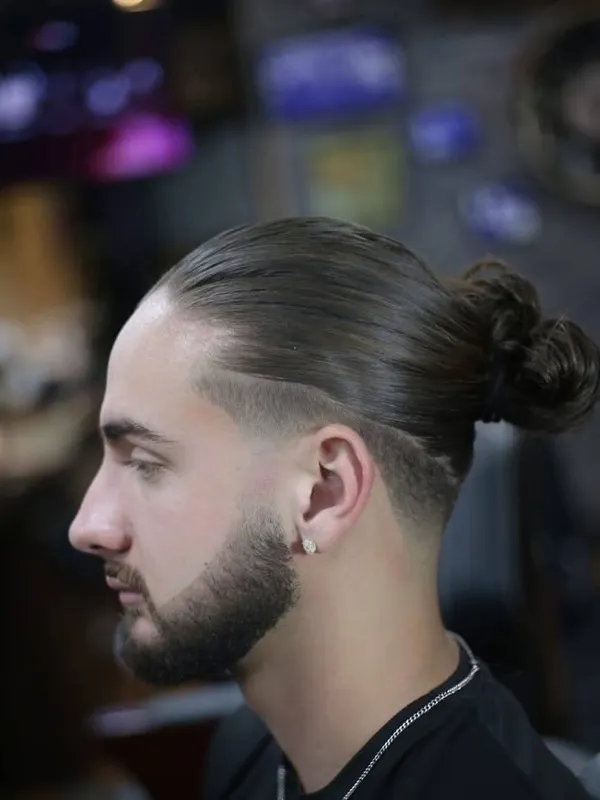 Man bun with a taper and full beard