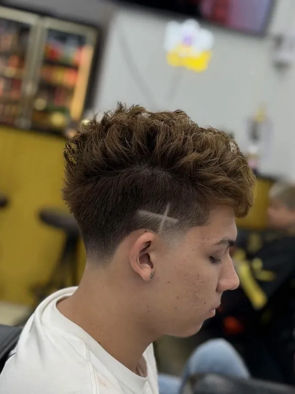 Curly crop with a taper and hair design