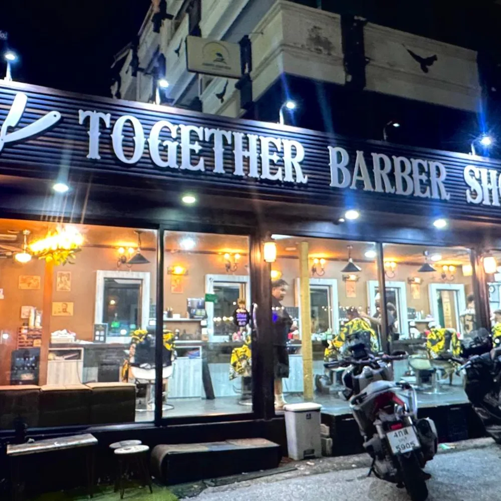 Jomtien Beach branch with its long Together Barber Shop sign lit at night