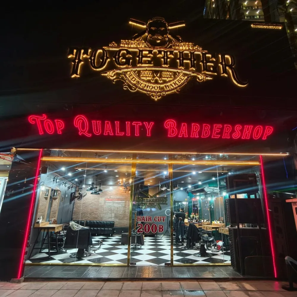 Naklua branch with a gold Together sign and red neon at night