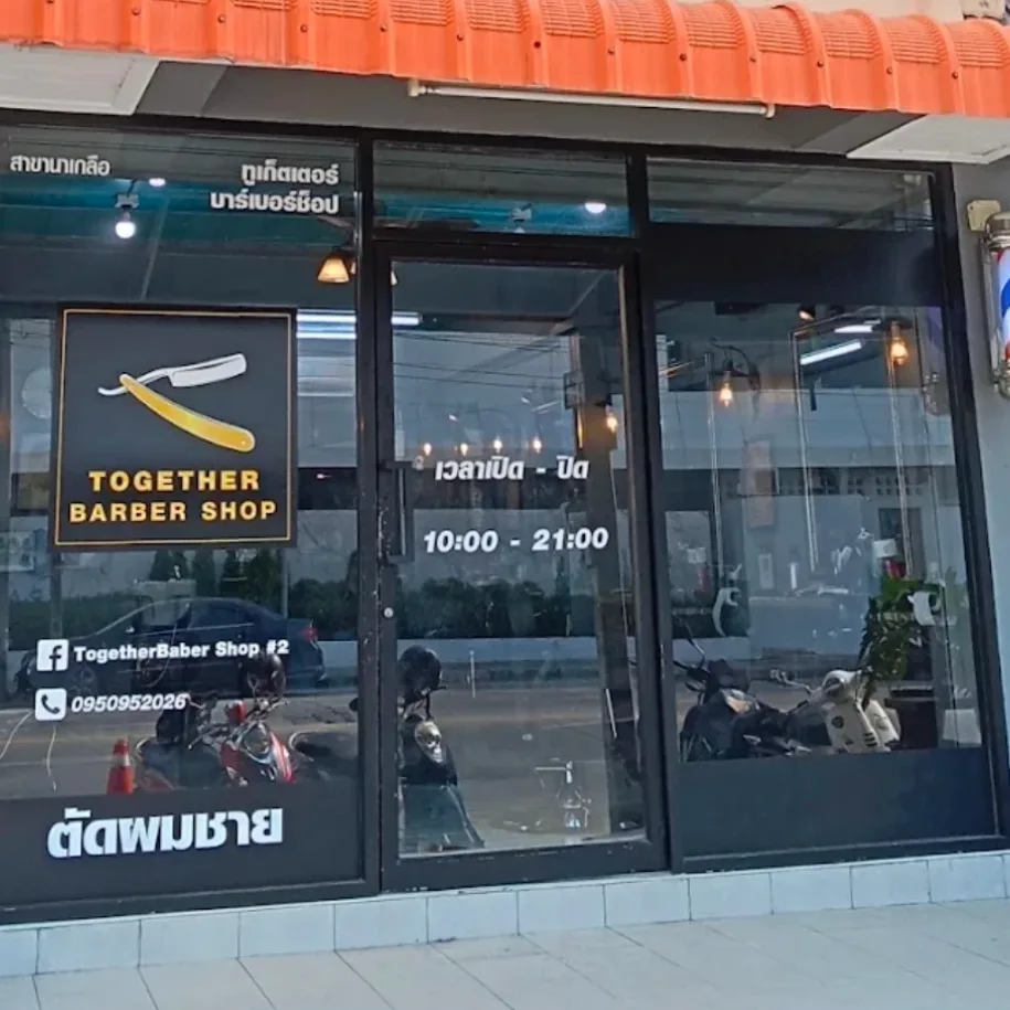 Naklua branch with its Together Barber Shop window sign and orange awning